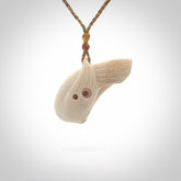 Hand carved huia bird made from cow bone pendant. Carved for NZ Pacific by Fumio Noguchi. This is a contemporary piece of jewellery that is carved with intricate detail and clearly shows a beautiful bird. We ship this free worldwide.
